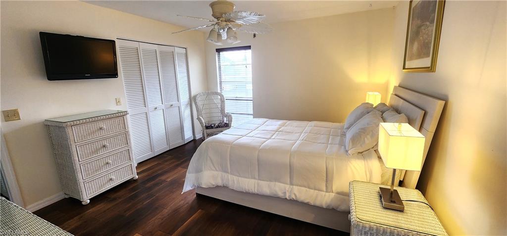 102 Georgetown Boulevard, Unit 102 Naples, FL 34112 - Photo 12 of 29 a bedroom with a bed and flat screen tv