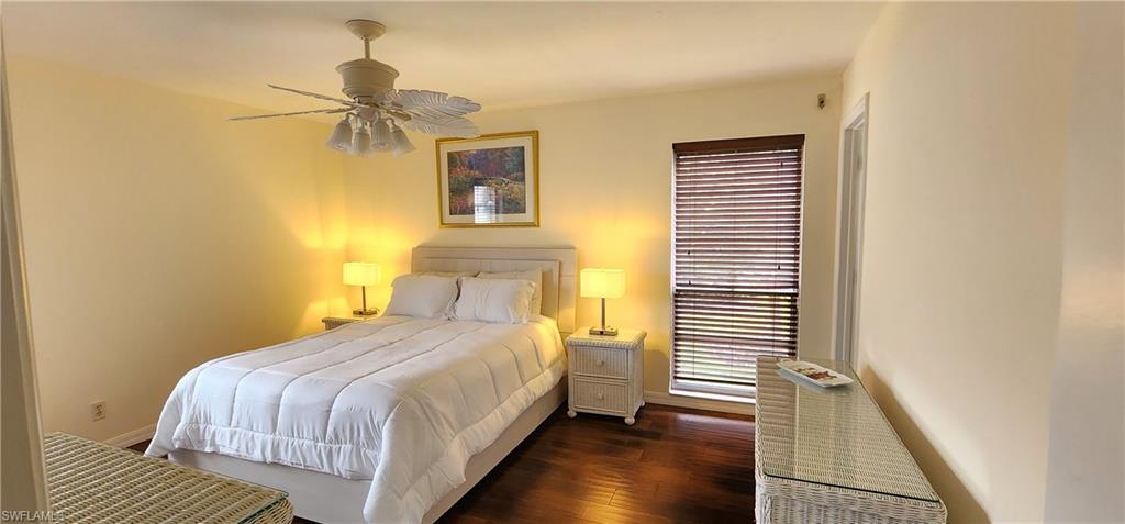 102 Georgetown Boulevard, Unit 102 Naples, FL 34112 - Photo 13 of 29 a bedroom with a bed and a night stand