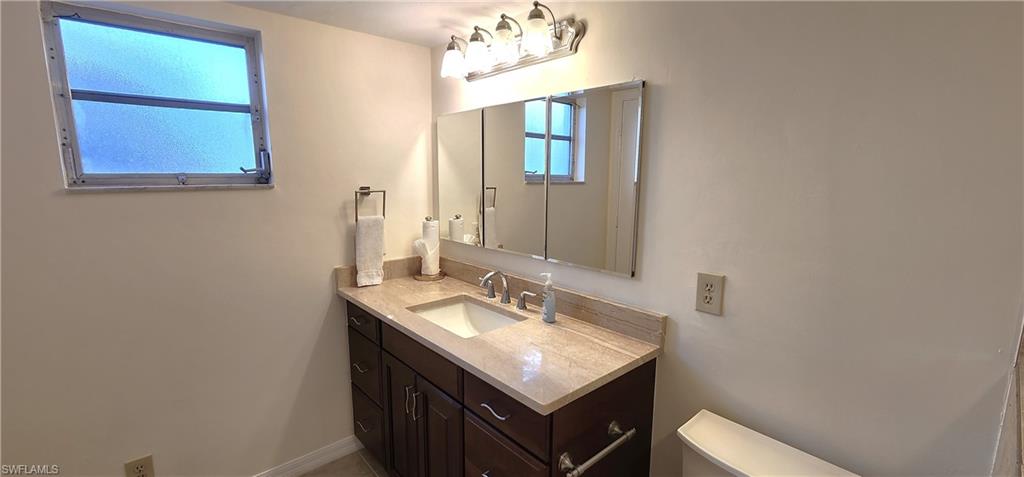 102 Georgetown Boulevard, Unit 102 Naples, FL 34112 - Photo 18 of 29 a bathroom with a sink and a mirror