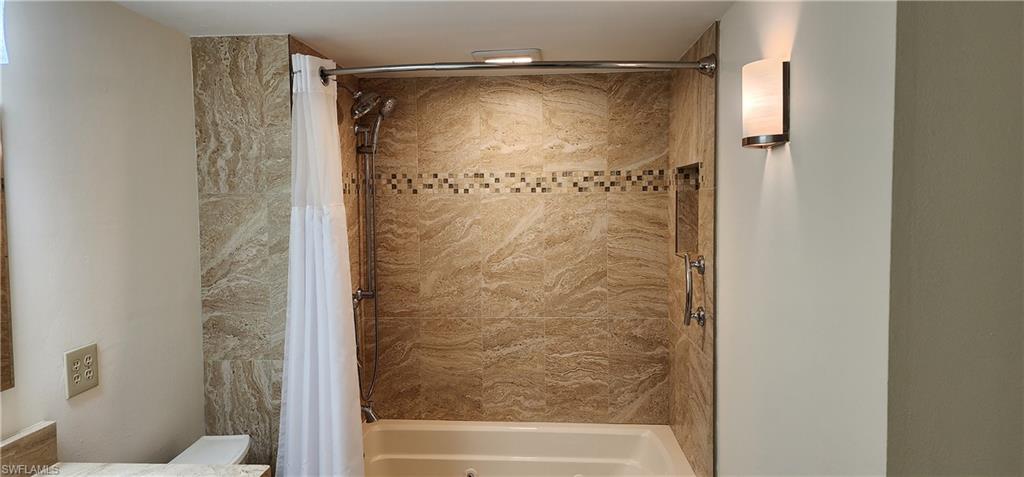 102 Georgetown Boulevard, Unit 102 Naples, FL 34112 - Photo 20 of 29 a bathroom with a glass shower door