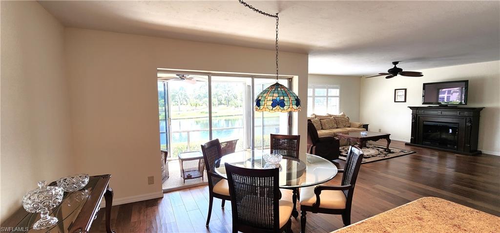 102 Georgetown Boulevard, Unit 102 Naples, FL 34112 - Photo 7 of 29 a view of a dining room with furniture window and wooden floor