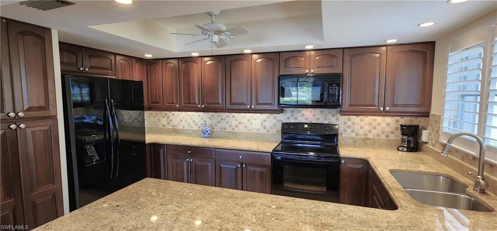 102 Georgetown Boulevard, Unit 102 Naples, FL 34112 - Photo 8 of 29 a kitchen with a stove and a refrigerator