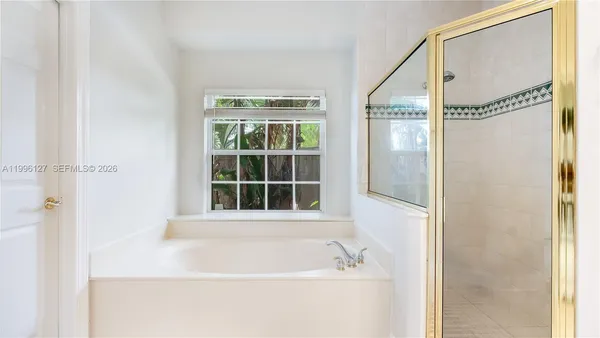 a bathroom with a bathtub and a shower