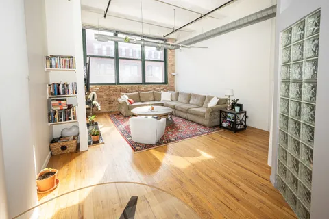 a living room with furniture and a floor to ceiling window