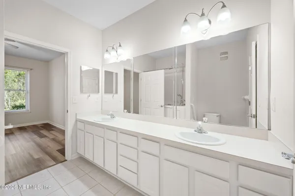 a bathroom with a sink double vanity and a mirror