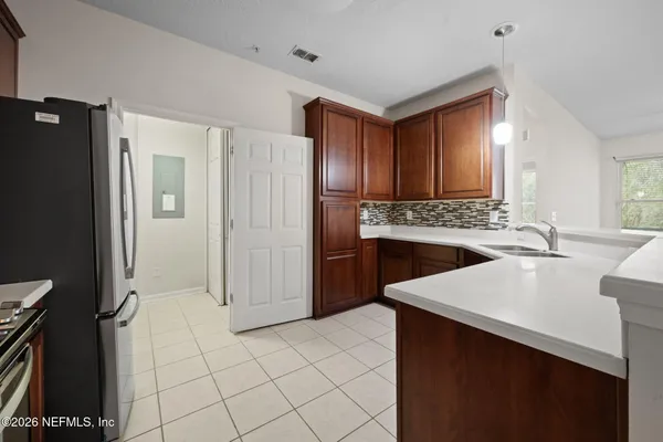 a kitchen with stainless steel appliances a refrigerator and a stove
