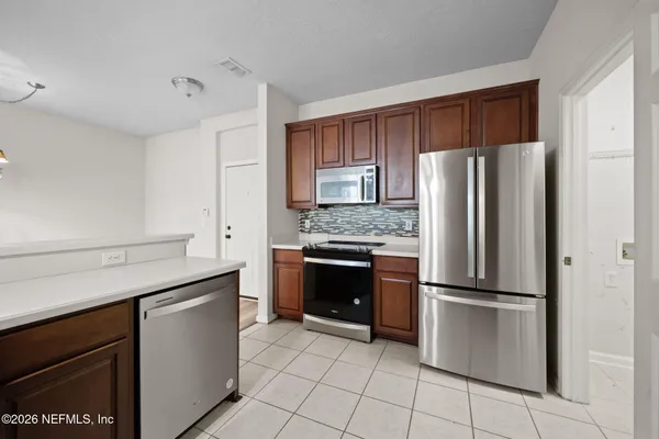 a kitchen with granite countertop stainless steel appliances and cabinets