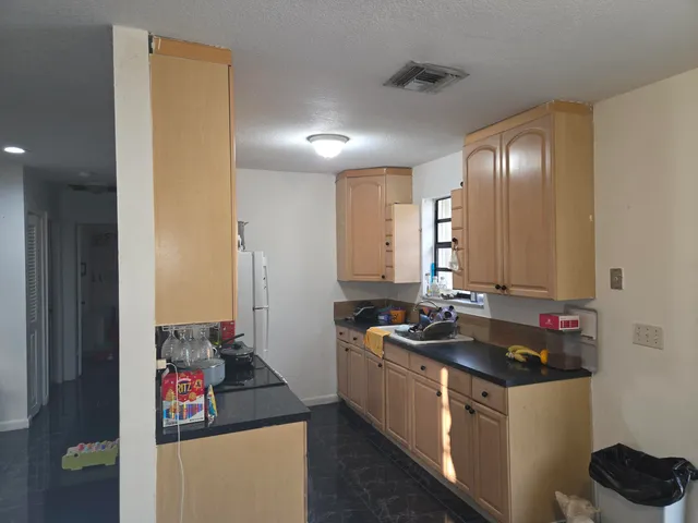 a kitchen with sink and refrigerator