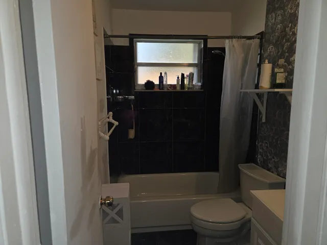 a bathroom with a toilet a sink and bathtub