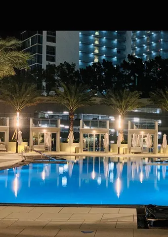 a view of a swimming pool with outdoor seating