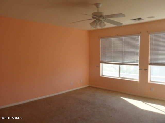 3469 East Cabazon Court Gilbert, AZ 85297 - Photo 19 of 25 an empty room with a window and a fan