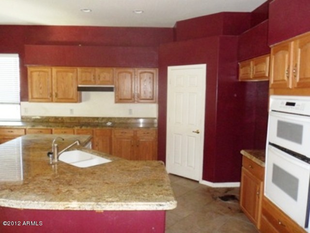 3469 East Cabazon Court Gilbert, AZ 85297 - Photo 7 of 25 a en suite bathroom with a granite countertop sink and a mirror