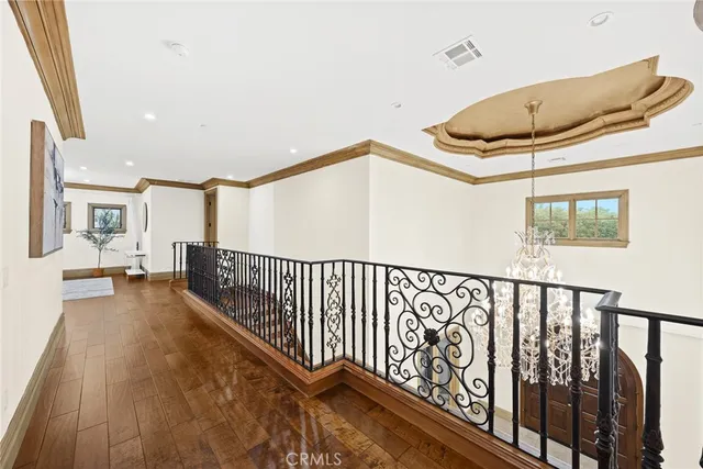 a spacious bedroom with a bed and a chandelier