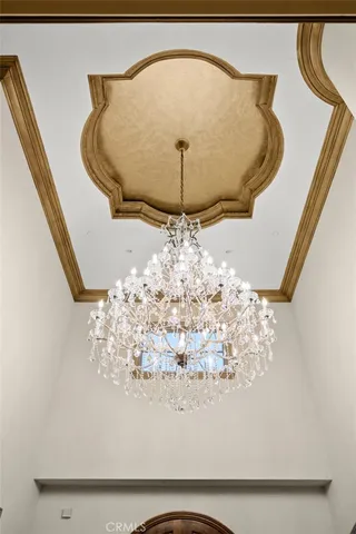 a living room with furniture chandelier and a rug