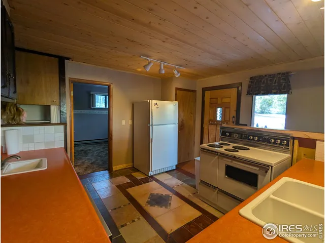 a view of empty room with wooden floor and fireplace