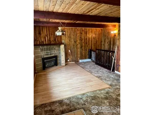 a view of a room with wooden floor and chandelier