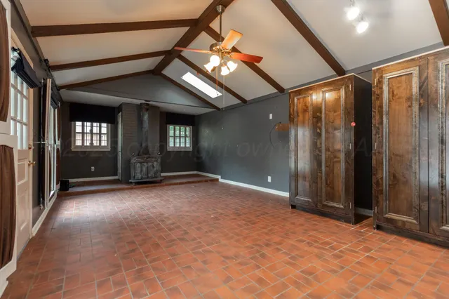 a view of a hallway with wooden floor and entryway