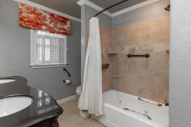 a bathroom with a tub a sink and a large mirror