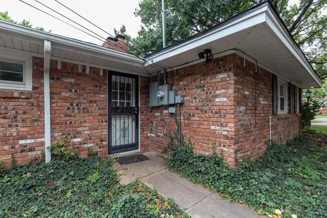 a front view of a house with brick walls