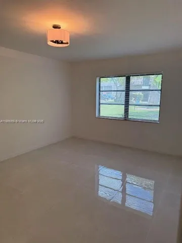 an empty room with a empty space and window