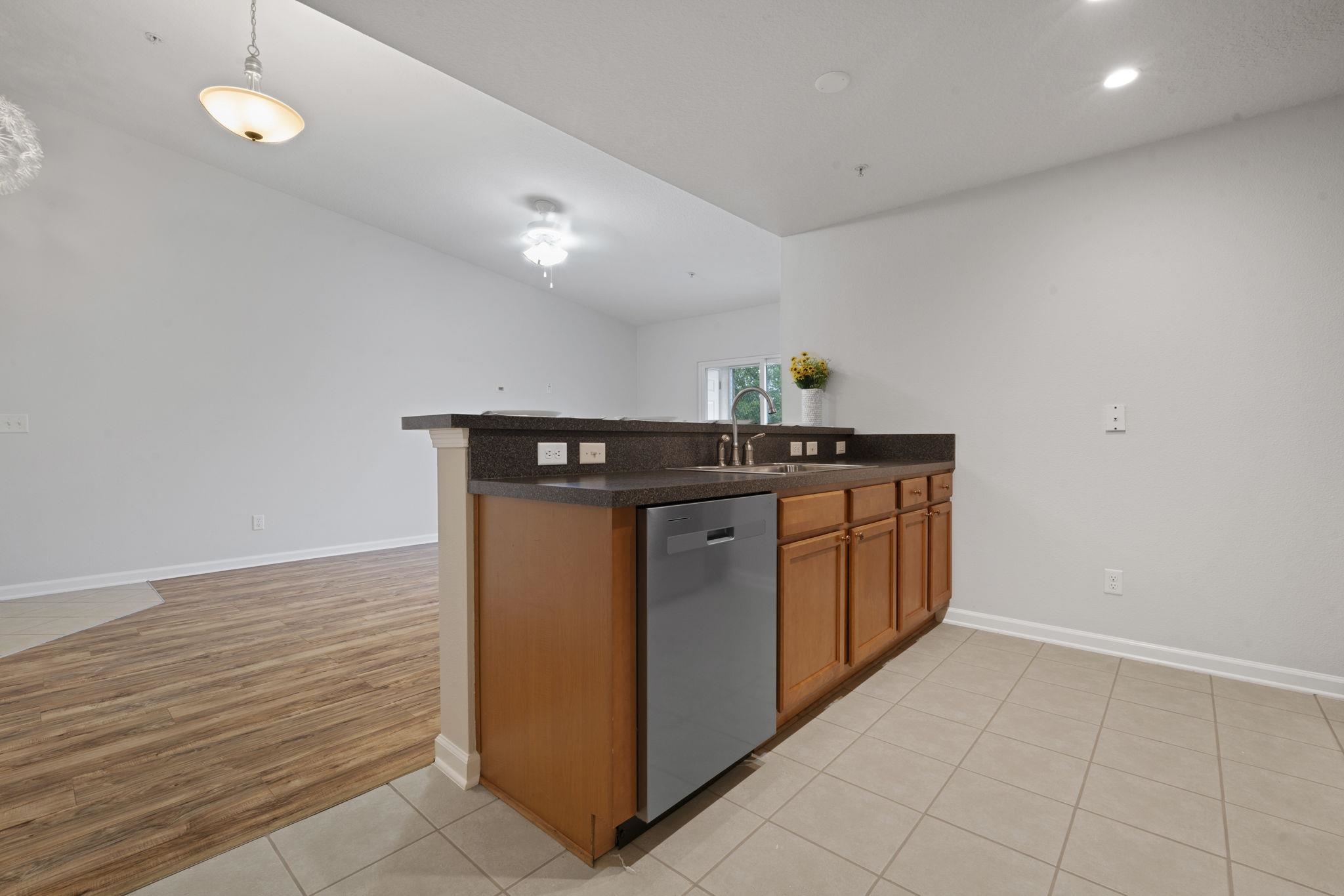 2441 Golden Lake Loop St. Augustine, FL 32084 - Photo 13 of 34 a kitchen with stainless steel appliances granite countertop a stove a sink and dishwasher