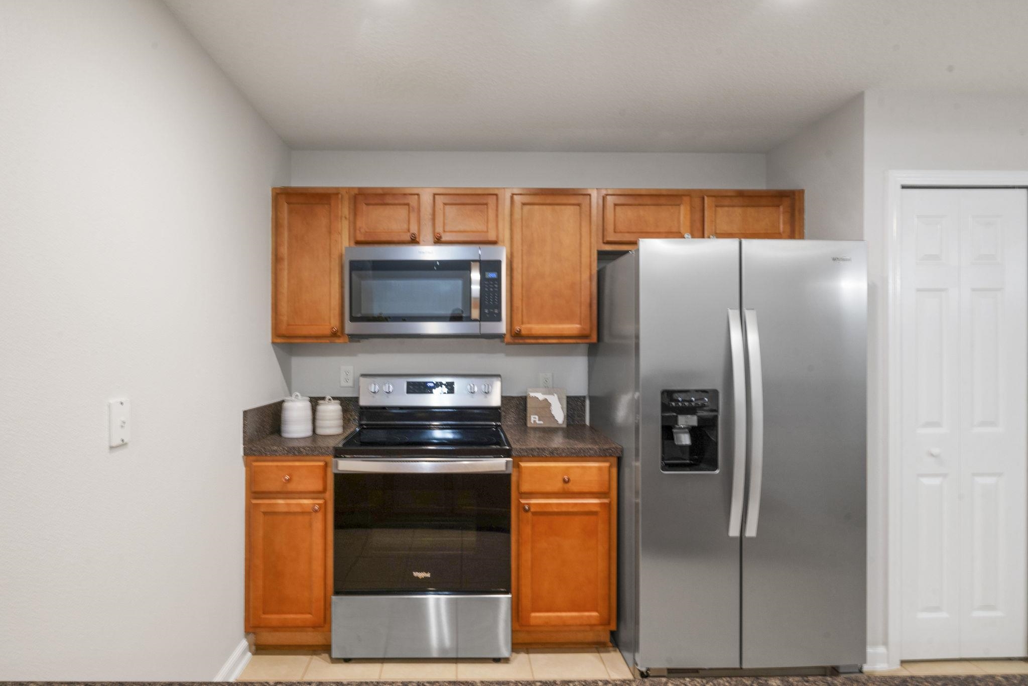 2441 Golden Lake Loop St. Augustine, FL 32084 - Photo 14 of 34 a kitchen with stainless steel appliances granite countertop a refrigerator a stove and a microwave