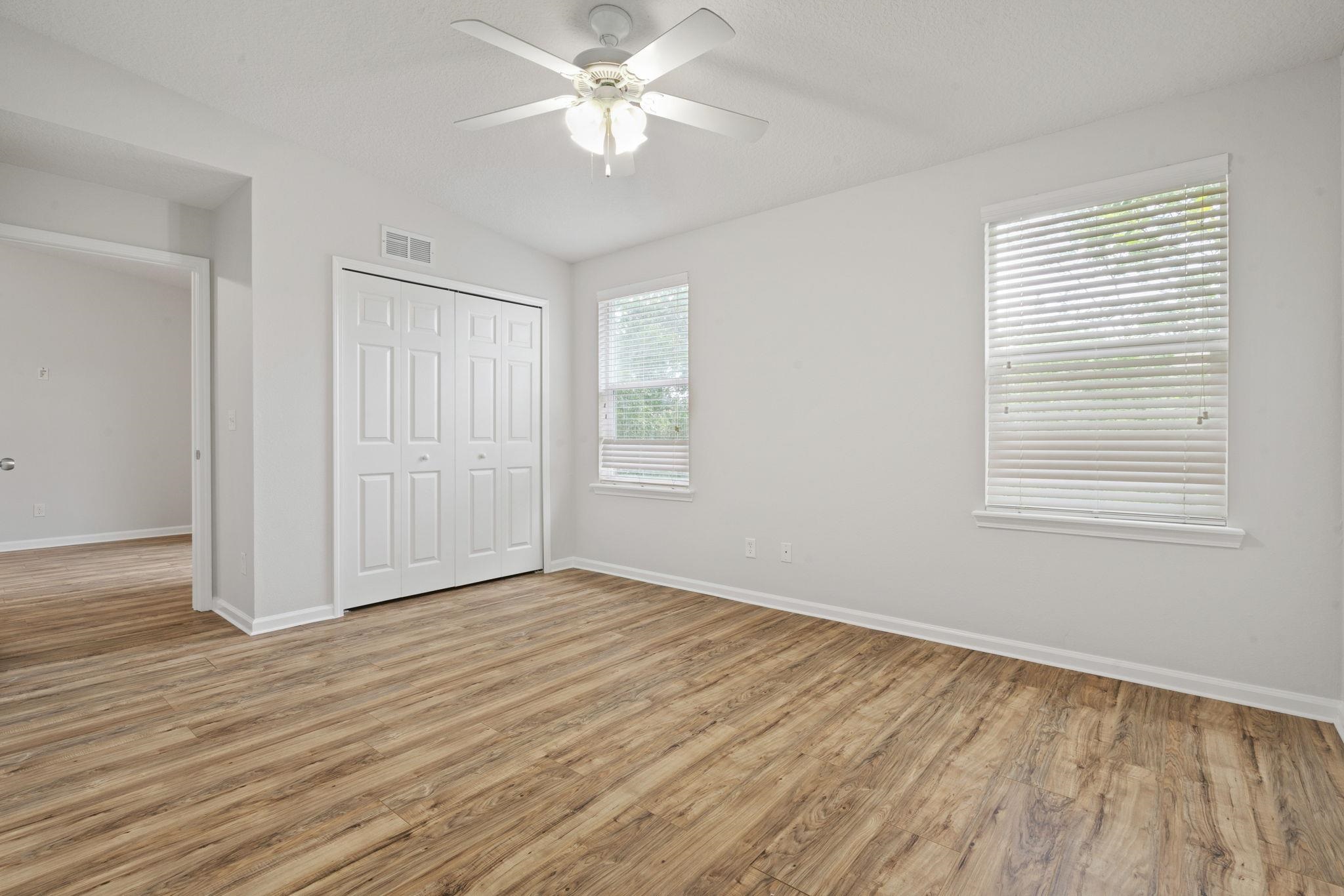 2441 Golden Lake Loop St. Augustine, FL 32084 - Photo 20 of 34 a view of an empty room with wooden floor and a window
