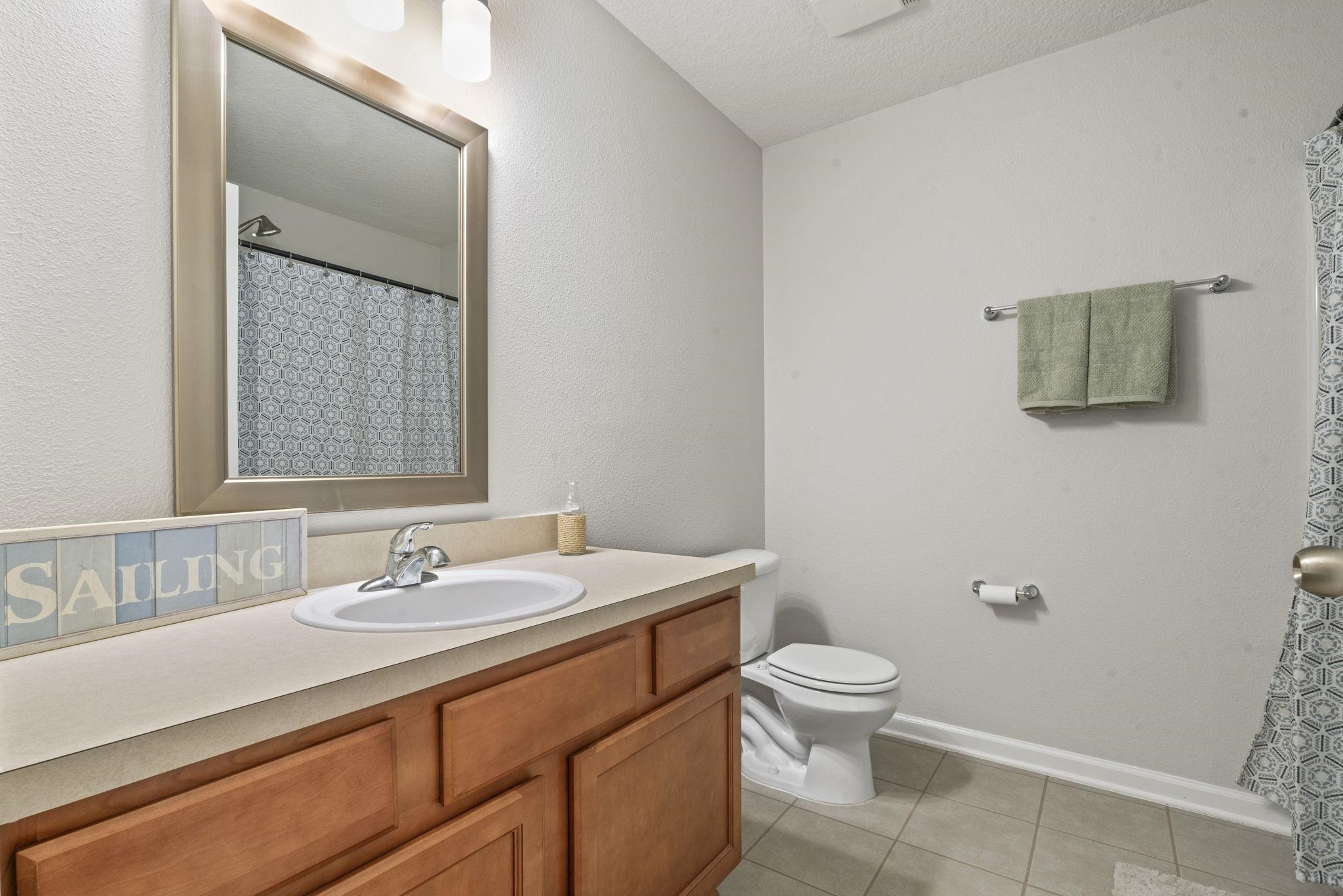 2441 Golden Lake Loop St. Augustine, FL 32084 - Photo 22 of 34 a bathroom with a sink a toilet and a mirror
