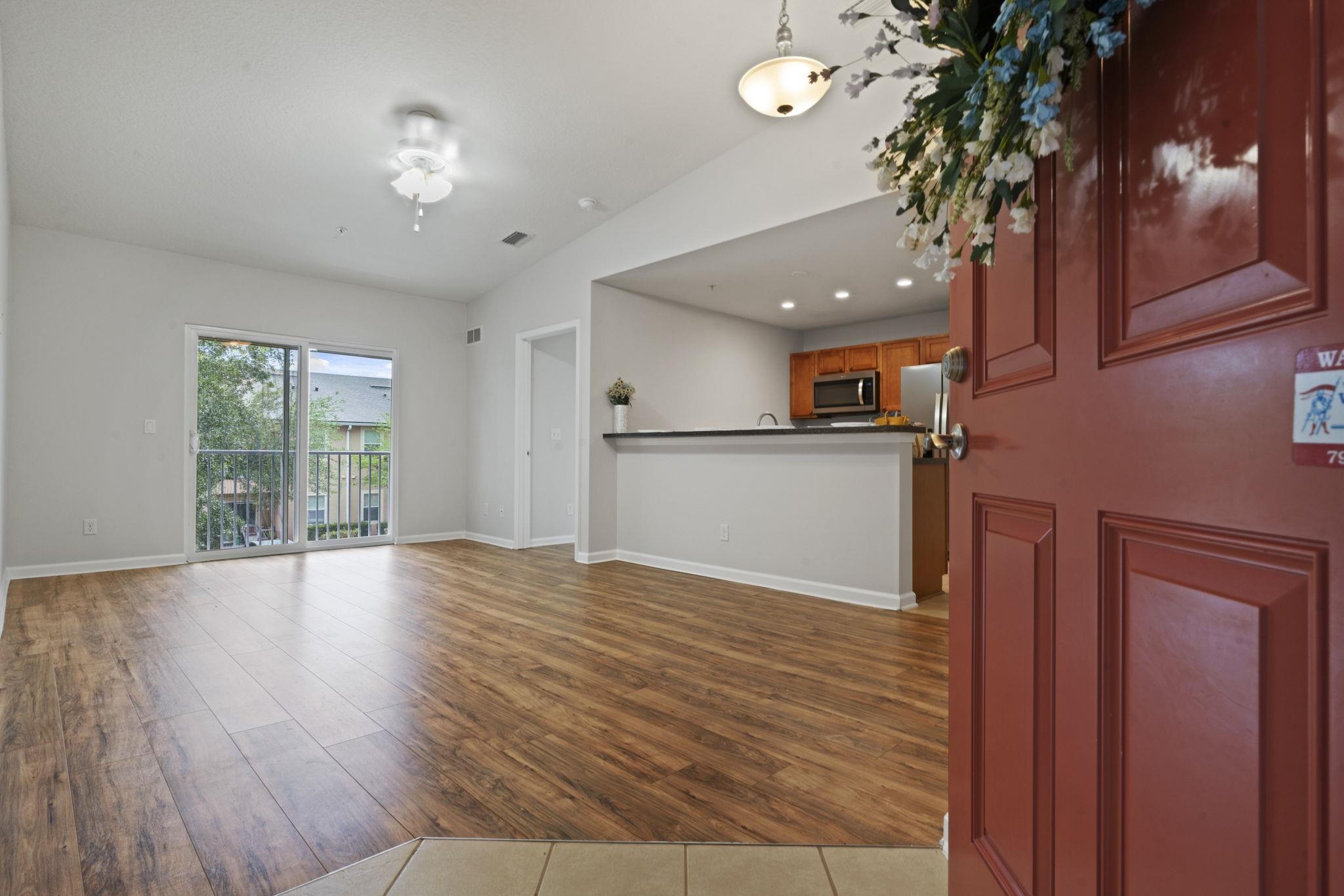 2441 Golden Lake Loop St. Augustine, FL 32084 - Photo 3 of 34 a view of a livingroom with wooden floor and a large window