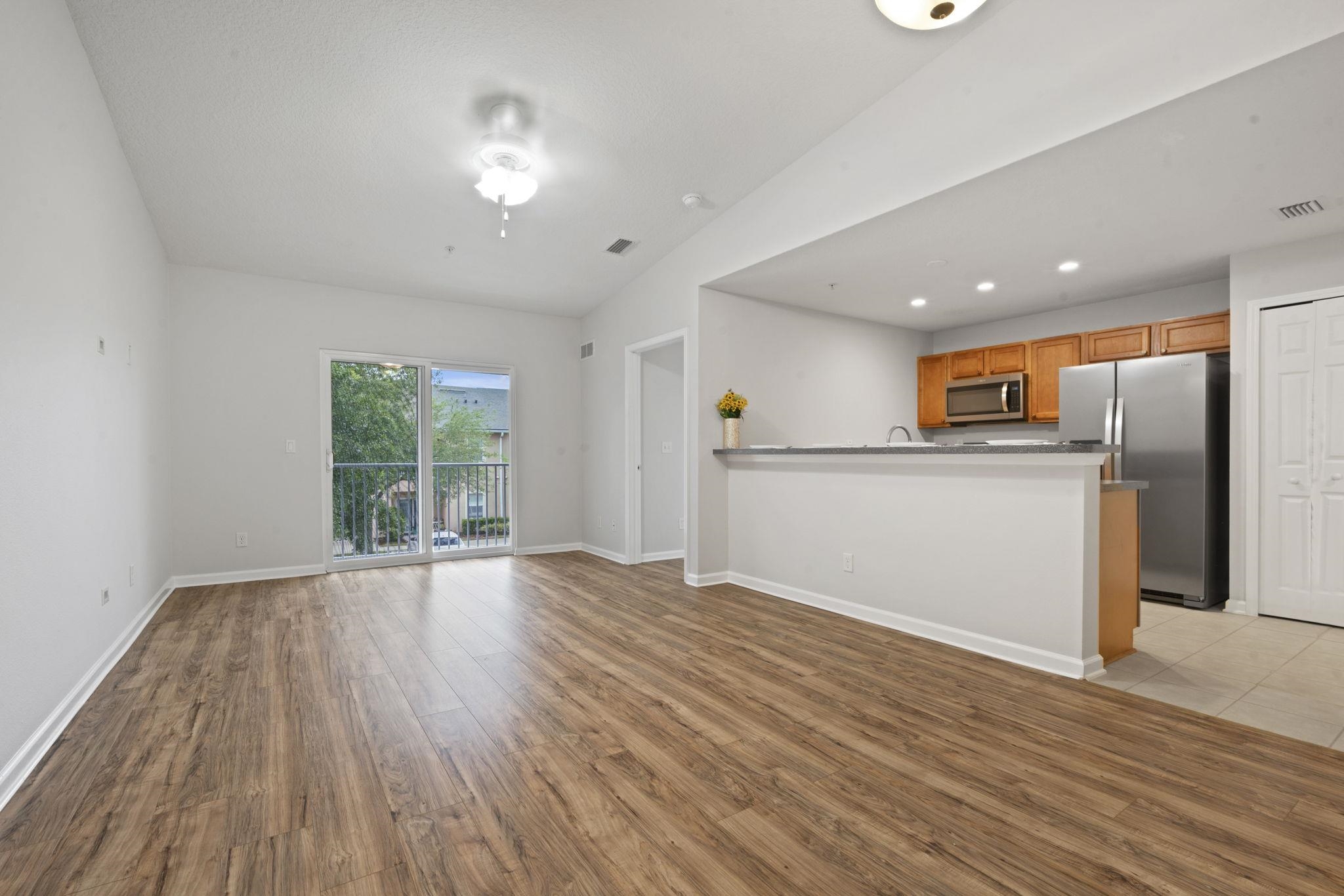 2441 Golden Lake Loop St. Augustine, FL 32084 - Photo 5 of 34 an empty room with wooden floor and a window