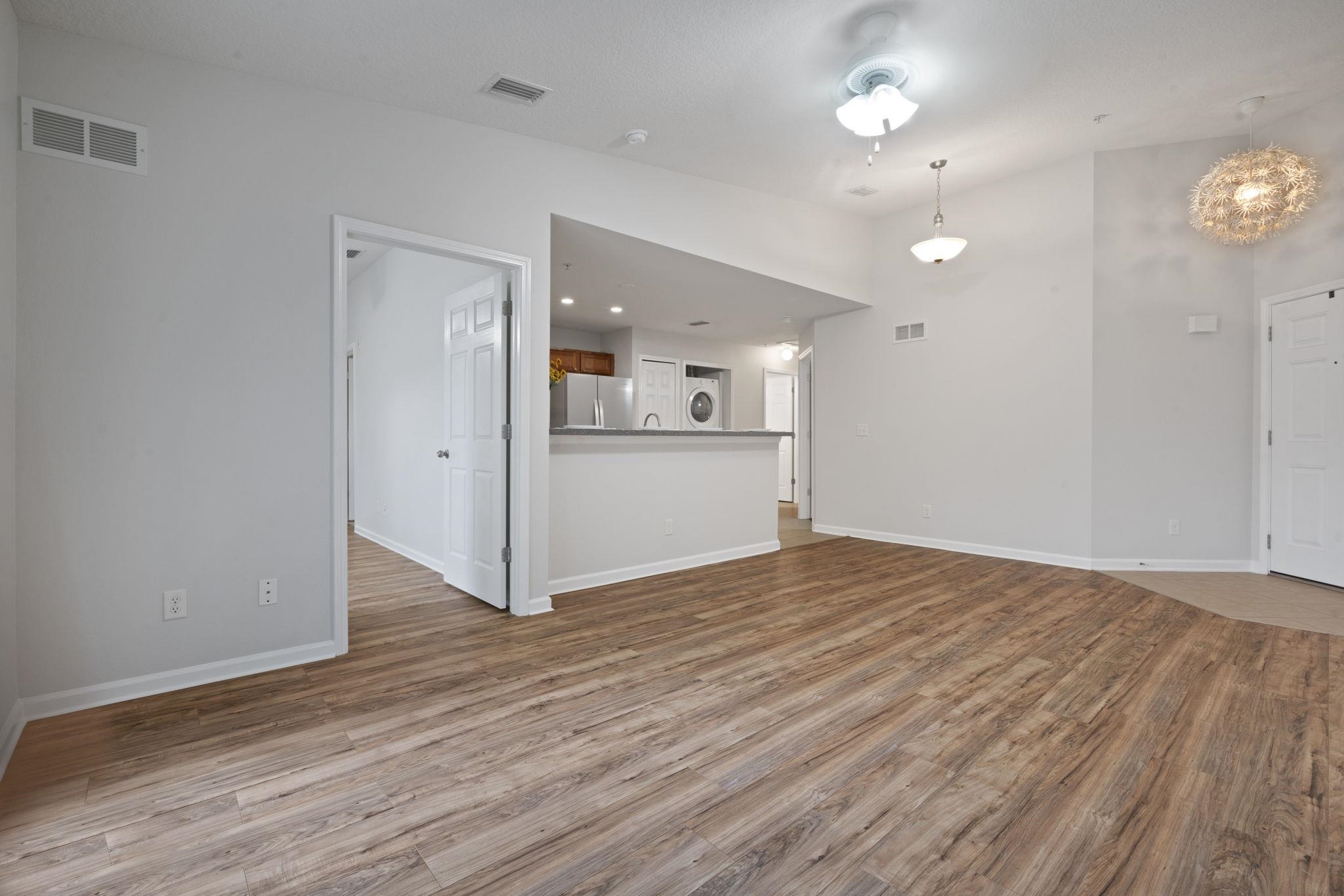 2441 Golden Lake Loop St. Augustine, FL 32084 - Photo 8 of 34 an empty room with wooden floor and windows