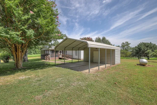 a view of a garden with a building in the background