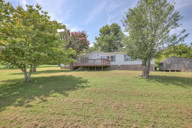 a view of a balcony with wooden floor and fence