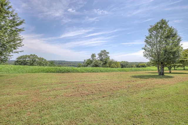 a view of house with backyard and deck