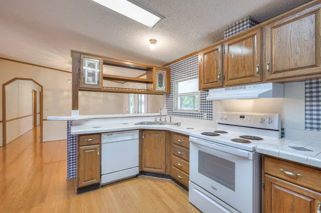 a kitchen with stainless steel appliances granite countertop a stove and a sink