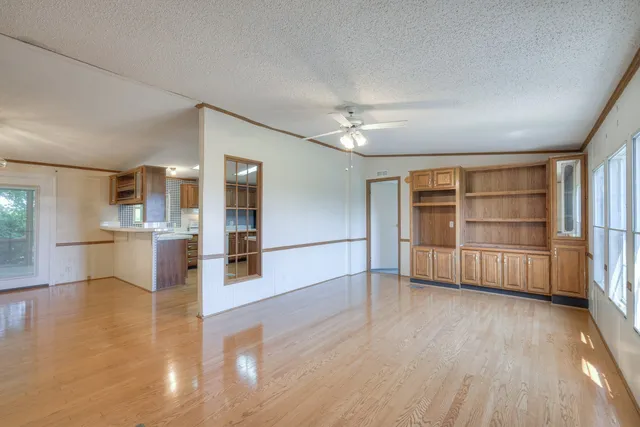 a view of a kitchen with wooden floor and a kitchen