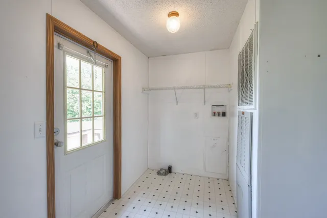 a view of a big room with wooden floor and a chandelier fan in a room