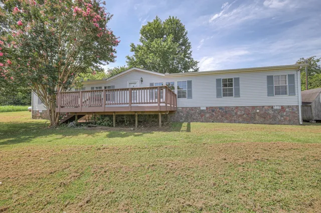 a view of a house with backyard and a garden
