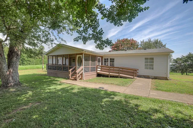 a view of a house with a yard porch and sitting area