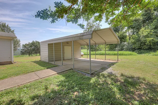 a view of a house with backyard and porch