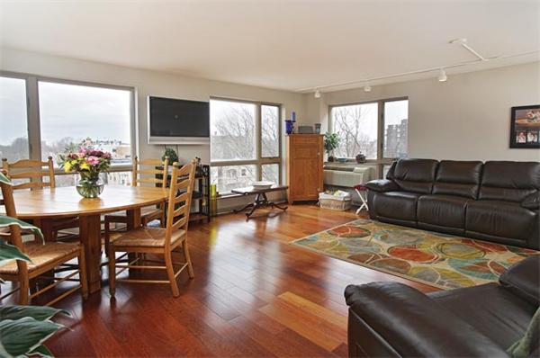 66 Winchester Street, Unit 401 Brookline, MA 02446 - Photo 2 of 5 a living room with furniture and a large window