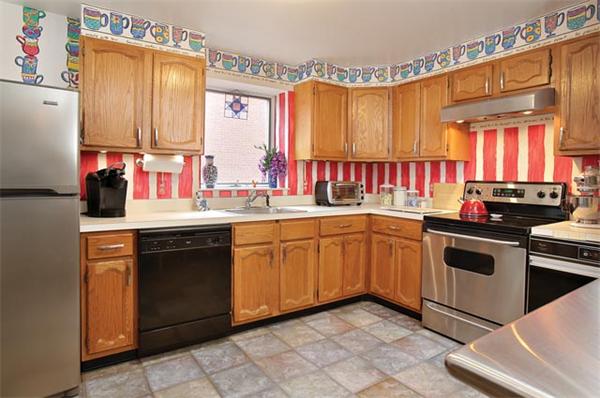 66 Winchester Street, Unit 401 Brookline, MA 02446 - Photo 3 of 5 a kitchen with a sink stove and cabinets
