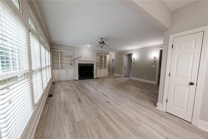 3245 Sparling Street Cumming, GA 30041 - Photo 11 of 59 a view of a livingroom with wooden floor a ceiling fan and window