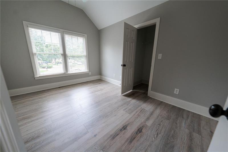 3245 Sparling Street Cumming, GA 30041 - Photo 16 of 59 an empty room with wooden floor and windows