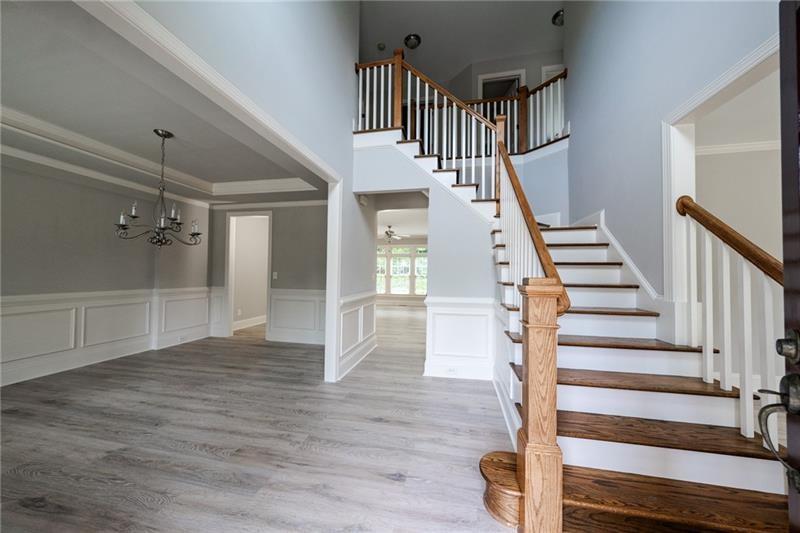 3245 Sparling Street Cumming, GA 30041 - Photo 17 of 59 a view of entryway and hall with wooden floor