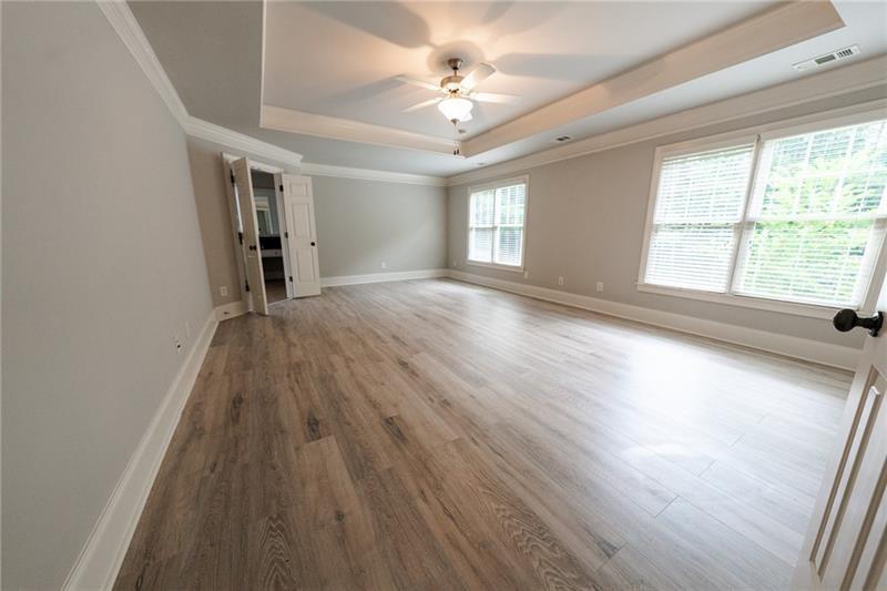 3245 Sparling Street Cumming, GA 30041 - Photo 23 of 59 wooden floor in an empty room with a window