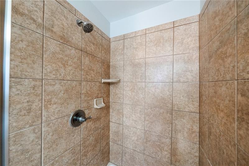 3245 Sparling Street Cumming, GA 30041 - Photo 26 of 59 a bathroom with a shower