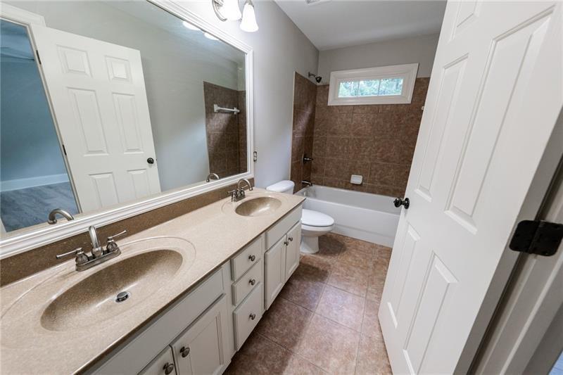 3245 Sparling Street Cumming, GA 30041 - Photo 30 of 59 a bathroom with a double vanity sink a and mirror