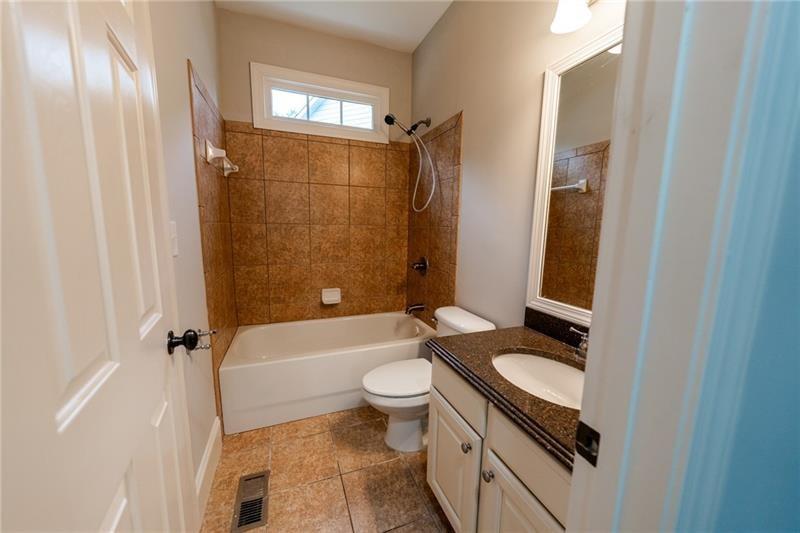 3245 Sparling Street Cumming, GA 30041 - Photo 31 of 59 a bathroom with a granite countertop sink toilet and shower
