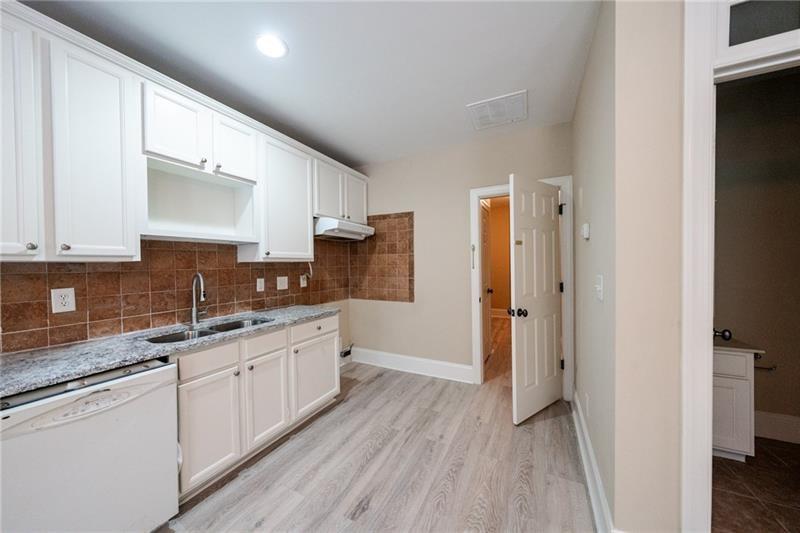 3245 Sparling Street Cumming, GA 30041 - Photo 37 of 59 a kitchen with a sink stove and refrigerator